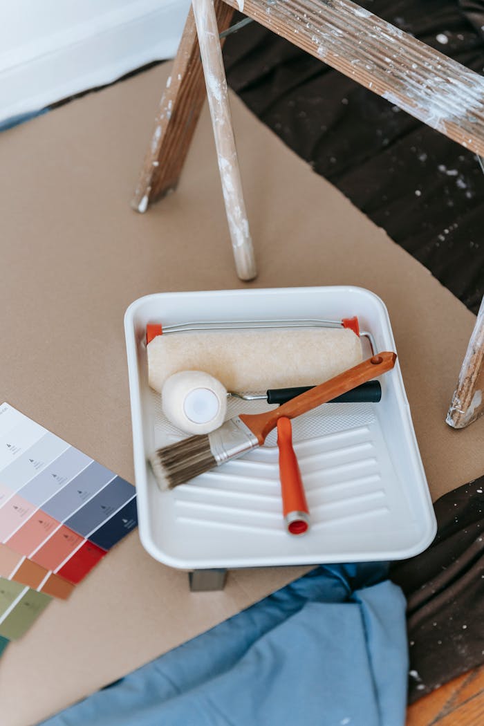 services-img A well-organized setup for a DIY home painting project, complete with tools and color swatches.